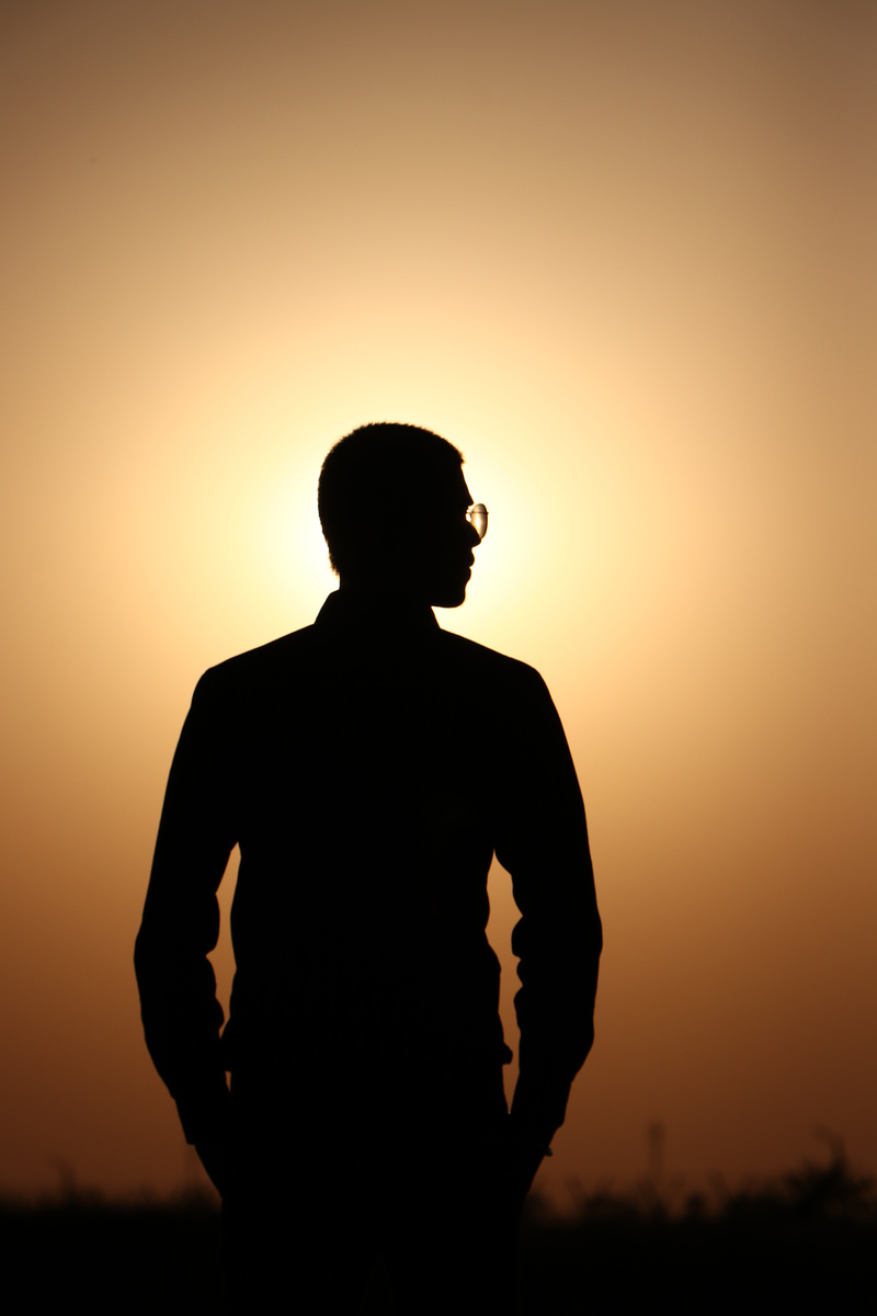 Silhouette of a Man Standing during Sunset